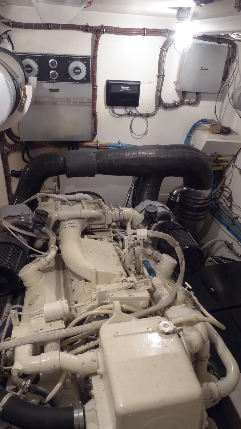 Slide: The Image of Engine room of a 1985 Hatteras 56 Motor Yacht, showcasing mechanical components. - 28