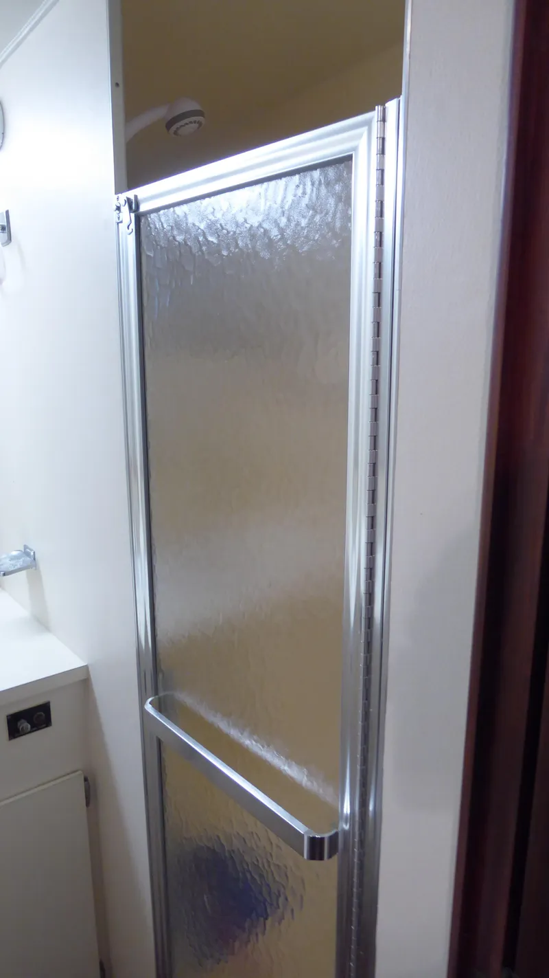 Slide: The Image of Shower door inside 1985 Hatteras 56 Motor Yacht bathroom. - 34