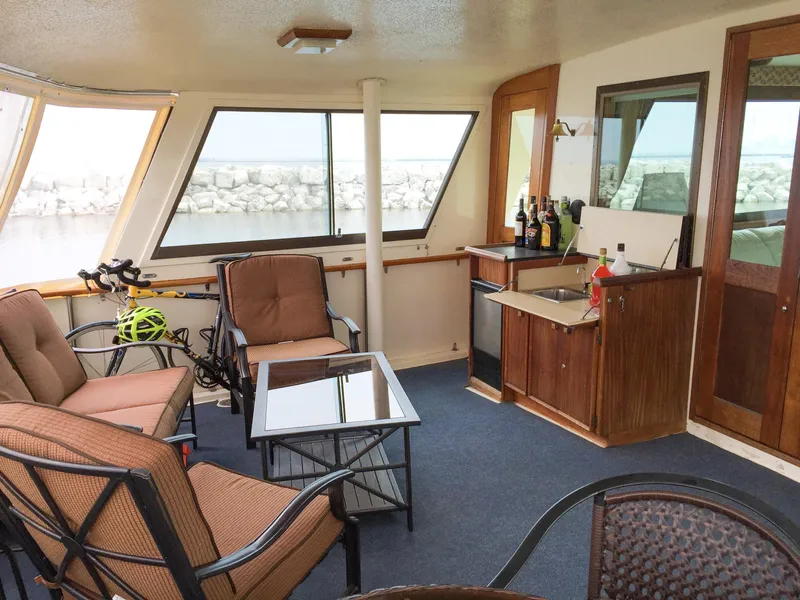 Slide: The Image of Interior of 1985 Hatteras 56 Motor Yacht with seating and mini bar area. - 4