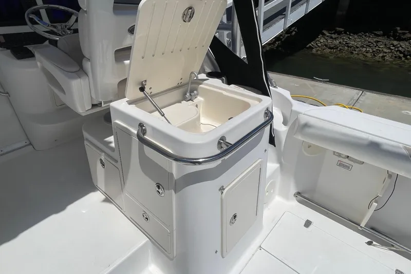 Slide: The Image of 2004 Boston Whaler 305 Conquest boat interior with open storage compartment. - 10