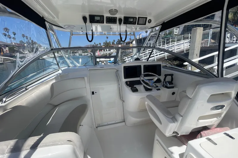 Slide: The Image of 2004 Boston Whaler 305 Conquest boat interior with helm, seating, and navigation equipment. - 11
