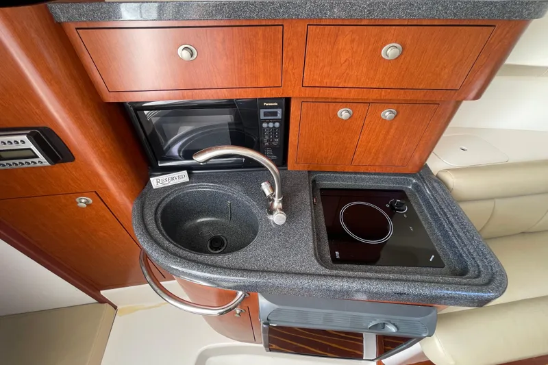 Slide: The Image of 2004 Boston Whaler 305 Conquest galley with sink, stove, and microwave. - 21