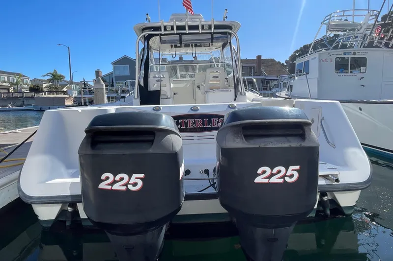 Slide: The Image of 2004 Boston Whaler 305 Conquest with twin 225 horsepower engines docked at marina. - 44