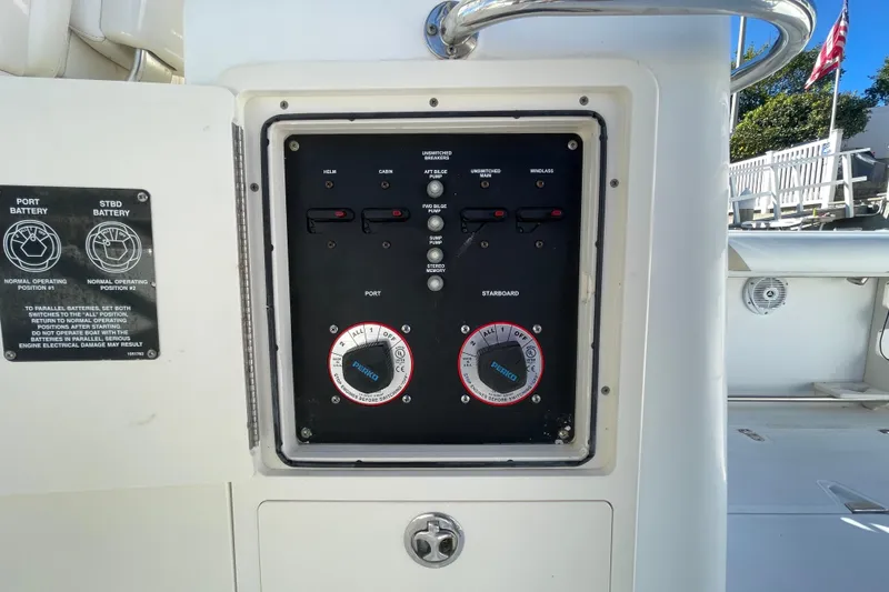 Slide: The Image of Control panel on a 2004 Boston Whaler 305 Conquest boat, featuring battery switches. - 45