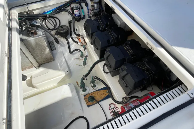 Slide: The Image of 2004 Boston Whaler 305 Conquest engine compartment with batteries and wiring. - 49