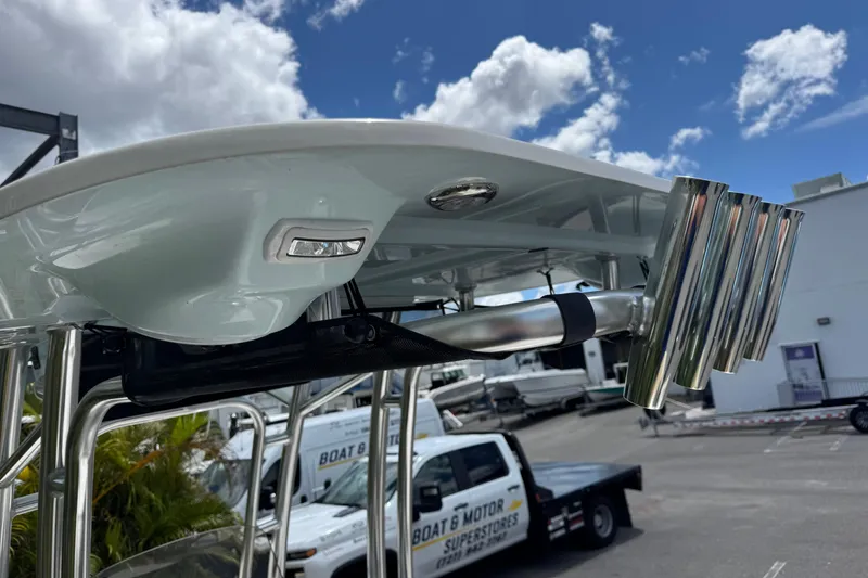 Slide: The Image of 2025 Key West 230 Bay Reef boat with rod holders and T-top under a cloudy sky. - 12