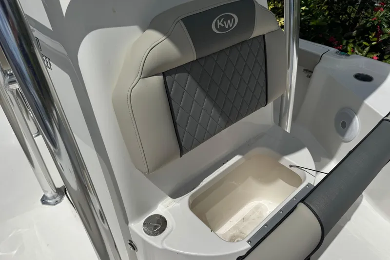 Slide: The Image of 2025 Key West 230 Bay Reef boat seat with storage compartment and sleek design. - 22