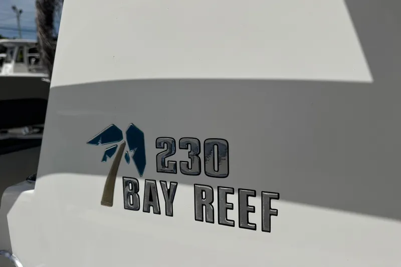 Slide: The Image of 2025 Key West 230 Bay Reef boat logo on white surface. - 23