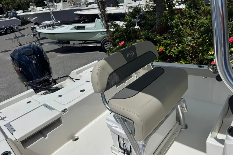 Slide: The Image of 2025 Key West 230 Bay Reef boat interior with seating and outboard motor. - 26