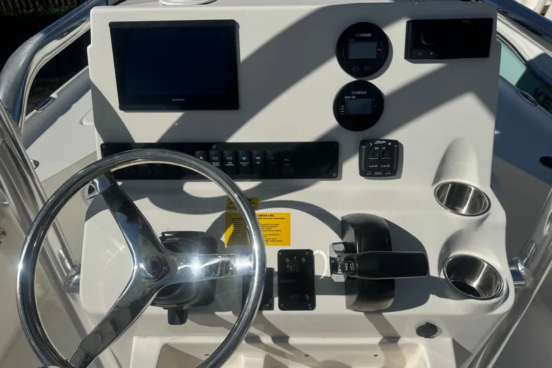 Slide: The Image of Steering console of 2026 Key West 230 Bay Reef boat with modern controls and displays. - 28