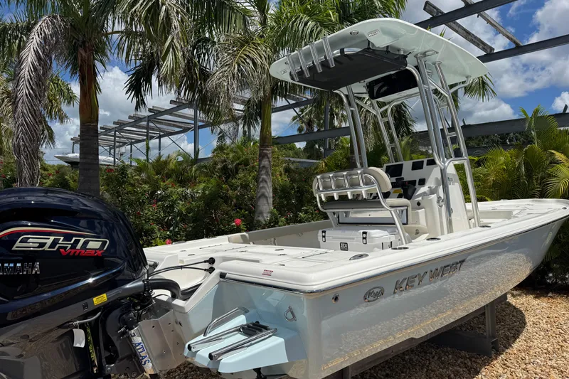 Slide: The Image of 2025 Key West 230 Bay Reef boat with Yamaha engine, surrounded by tropical foliage. - 3