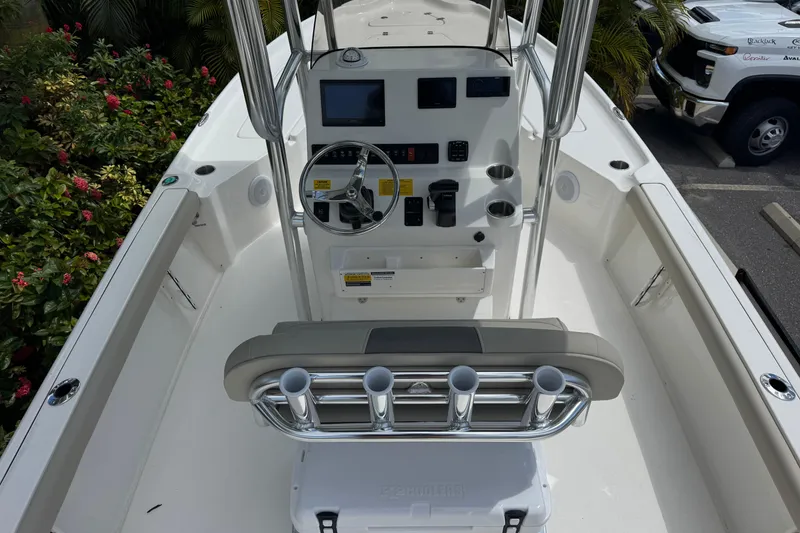 Slide: The Image of 2025 Key West 230 Bay Reef boat interior with steering console and rod holders. - 9