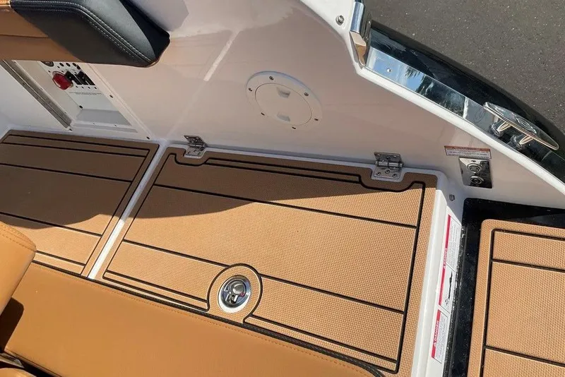 Slide: The Image of 2026 Chaparral SSX 276 boat interior with tan flooring and sleek design elements. - 19