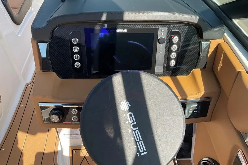 Slide: The Image of 2026 Chaparral SSX 276 boat dashboard with Simrad display and Gussi steering wheel. - 24