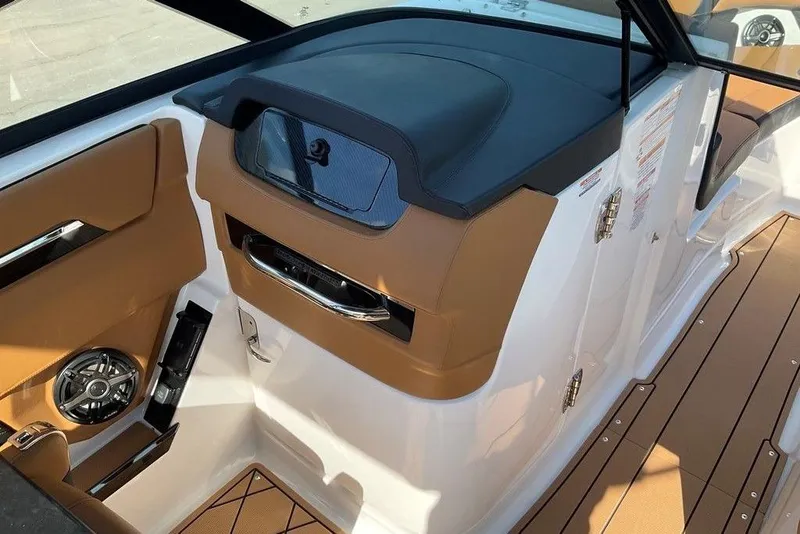 Slide: The Image of 2026 Chaparral SSX 276 boat interior with tan and black accents, featuring a speaker and storage. - 31