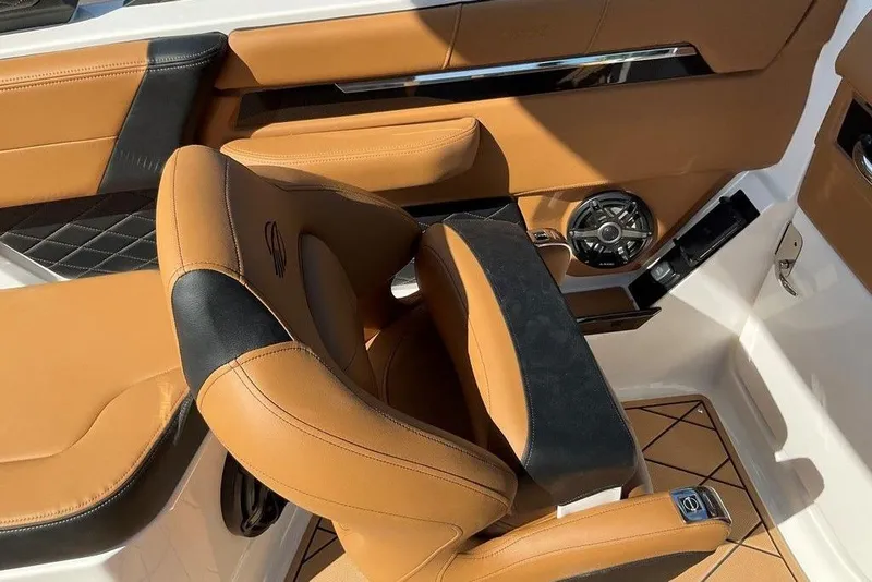 Slide: The Image of 2026 Chaparral SSX 276 boat interior with tan and black leather seating. - 32
