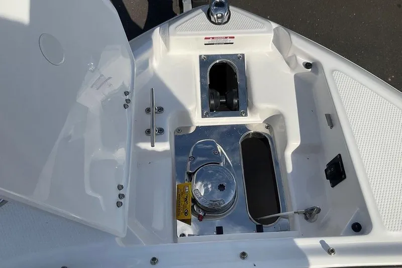 Slide: The Image of 2026 Chaparral SSX 276 boat anchor compartment with open hatch and winch system. - 37