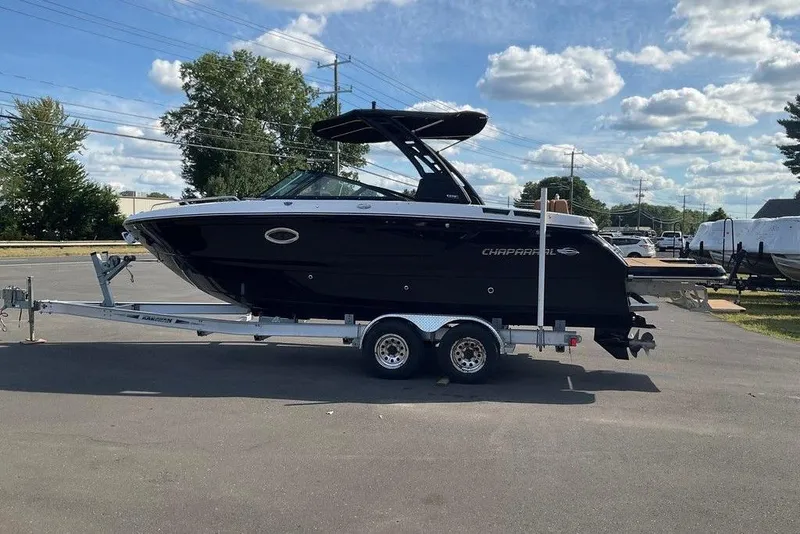 Slide: The Image of 2026 Chaparral SSX 276 boat on trailer under a partly cloudy sky. - 4