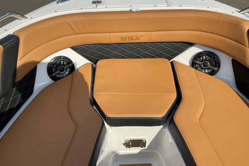 Slide: The Image of 2026 Chaparral SSX 276 boat interior with tan leather seating and built-in speakers. - 43