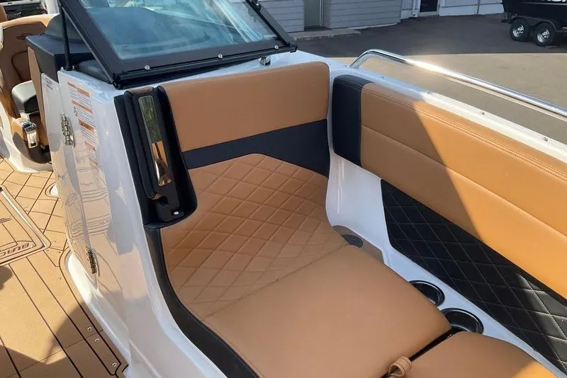Slide: The Image of 2026 Chaparral SSX 276 boat interior with tan and black quilted seating. - 45