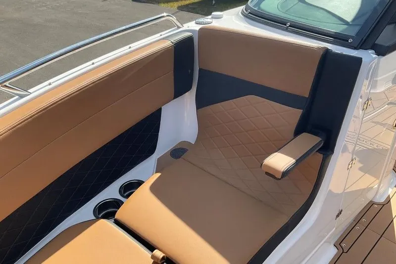 Slide: The Image of Luxurious seating on 2026 Chaparral SSX 276 boat with tan and black upholstery. - 49