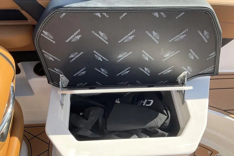 Slide: The Image of 2026 Chaparral SSX 276 boat storage compartment with branded cover open. - 51