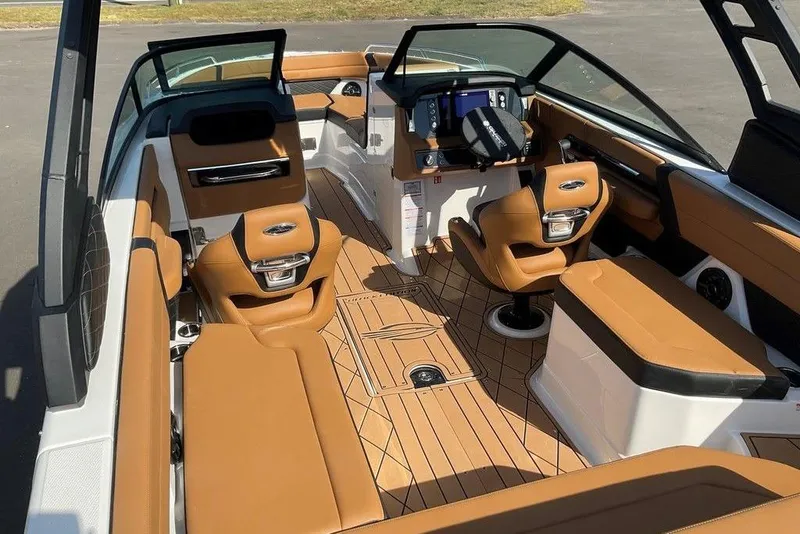 Slide: The Image of 2026 Chaparral SSX 276 boat interior with luxurious tan seating and modern dashboard. - 55
