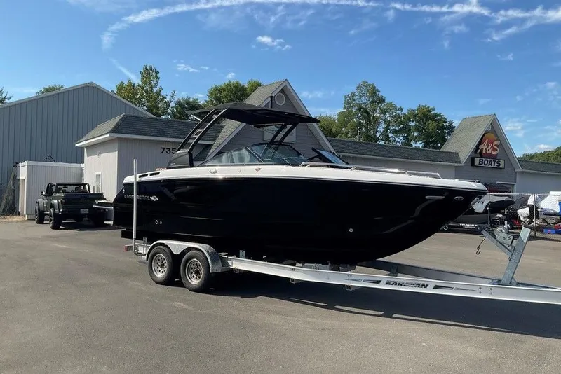 Slide: The Image of 2026 Chaparral SSX 276 boat on trailer at dealership, clear sky background. - 6