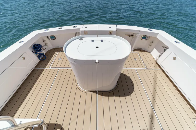 Slide: The Image of 2009 Egg Harbor 37 SportYacht deck with central console, surrounded by ocean water. - 20