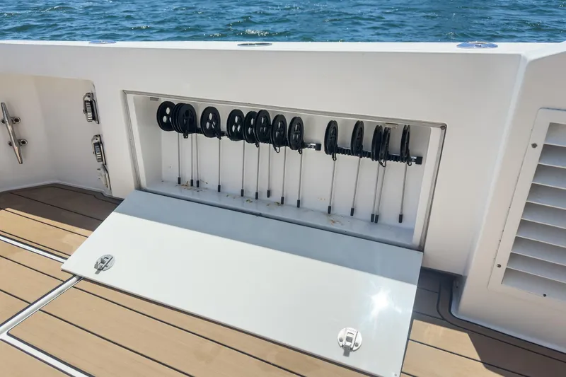 Slide: The Image of Storage compartment on 2009 Egg Harbor 37 SportYacht with fishing rod holders, open on deck. - 22