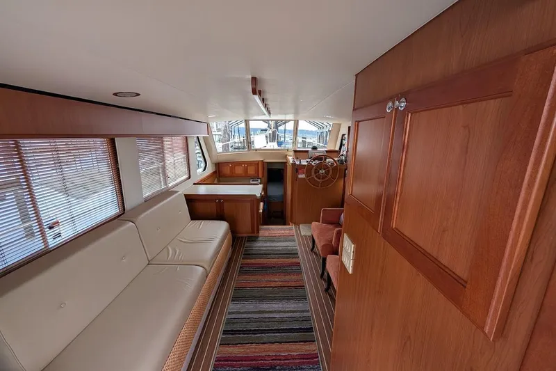Slide: The Image of Interior of 2008 Mainship 38 yacht with wood paneling and striped rug. - 11