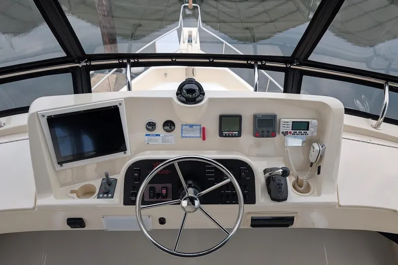 Slide: The Image of Helm of 2008 Mainship 38 boat with navigation equipment and steering wheel. - 24