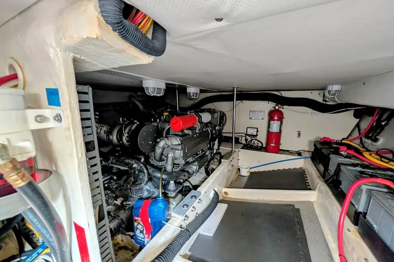 Slide: The Image of Engine room of 2008 Mainship 38 boat with visible machinery and fire extinguisher. - 28