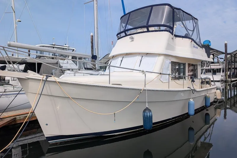 The Image of 2008 Mainship 34 yacht docked at marina, featuring a spacious cabin and flybridge. - 0