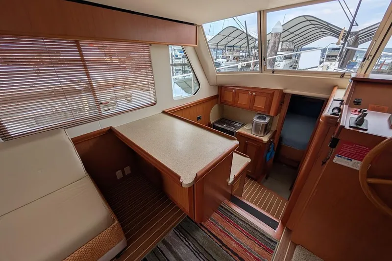 Slide: The Image of Interior of 2008 Mainship 38 yacht with kitchen, seating, and large windows. - 15