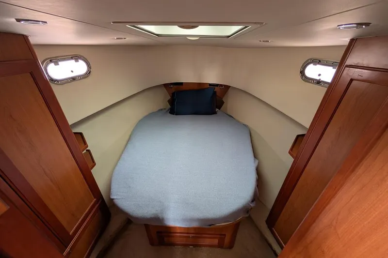 Slide: The Image of Cozy cabin interior of 2008 Mainship 38 with bed and wooden cabinetry. - 20