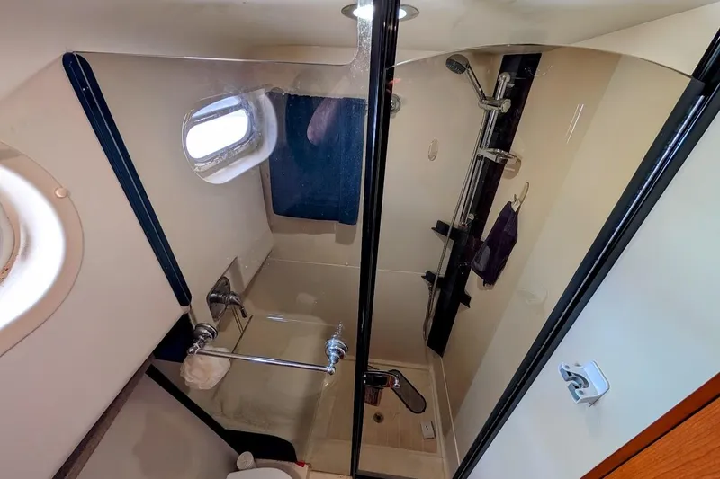 Slide: The Image of Bathroom interior of 2008 Mainship 38 yacht with shower and porthole window. - 22