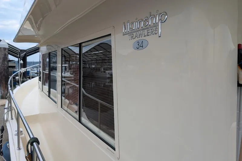 Slide: The Image of 2008 Mainship 38 yacht side view with windows and railing at dock. - 5