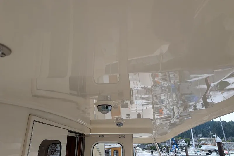 Slide: The Image of 2008 Mainship 38 boat interior ceiling with glossy finish and marina view. - 8