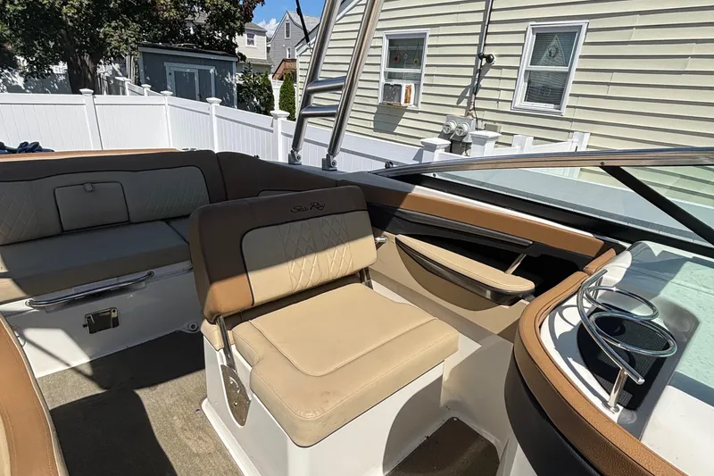 Slide: The Image of Interior of a 2015 Sea Ray 240 Sundeck boat with beige seating. - 12
