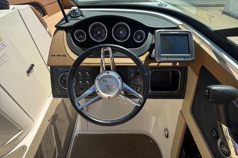 Slide: The Image of Steering console of 2015 Sea Ray 240 Sundeck with gauges and navigation system. - 16