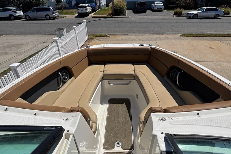 Slide: The Image of 2015 Sea Ray 240 Sundeck boat with spacious seating and beige upholstery. - 20