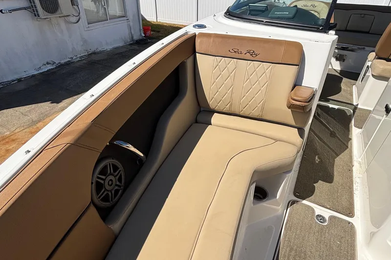 Slide: The Image of 2015 Sea Ray 240 Sundeck interior with tan seating and speaker detail. - 22