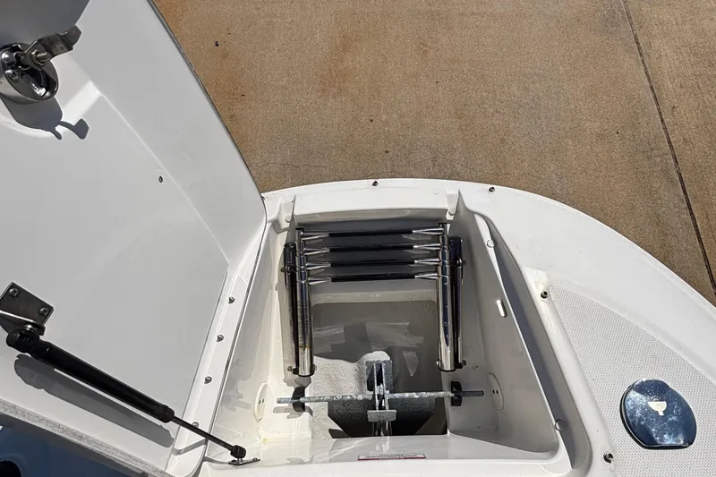 Slide: The Image of Open storage compartment on 2015 Sea Ray 240 Sundeck boat, showing ladder and anchor. - 24