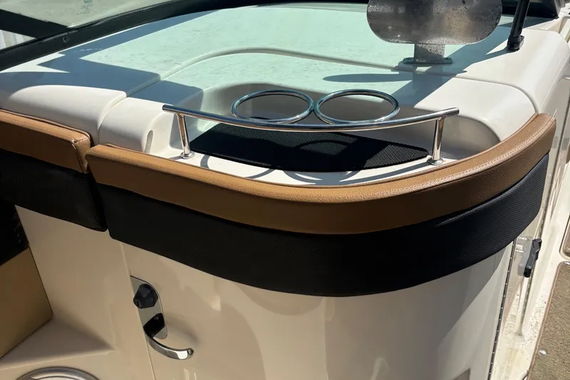 Slide: The Image of 2015 Sea Ray 240 Sundeck boat interior with cup holders and sleek design. - 25