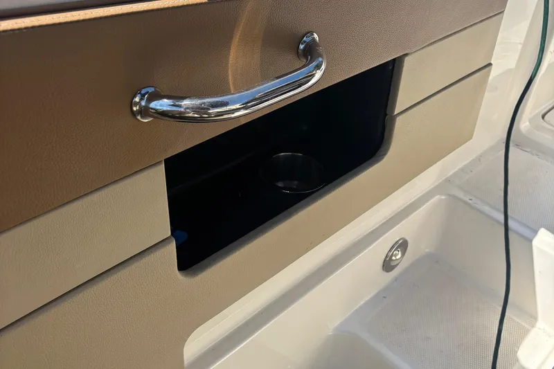 Slide: The Image of Interior storage compartment of 2015 Sea Ray 240 Sundeck boat with chrome handle. - 30