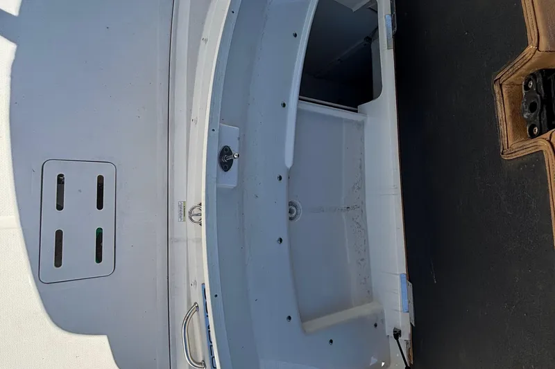 Slide: The Image of 2015 Sea Ray 240 Sundeck interior view, showcasing storage compartment and seating area. - 33