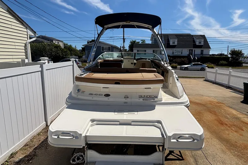 Slide: The Image of 2015 Sea Ray 240 Sundeck boat parked in driveway, rear view. - 5