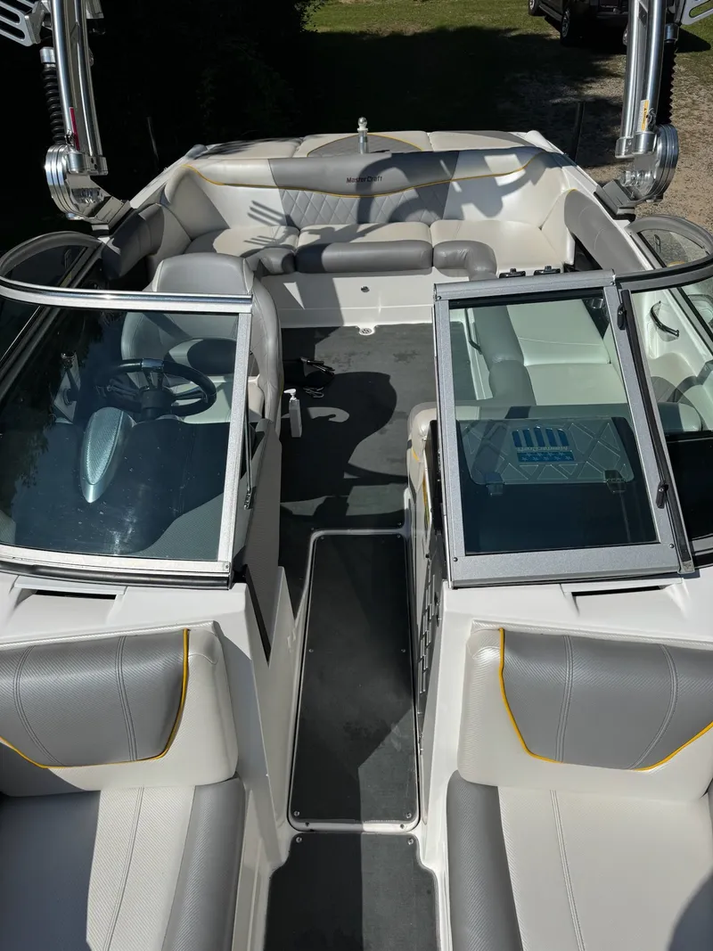 Slide: The Image of 2012 MasterCraft X-15 boat interior with gray seating and open windshield. - 10