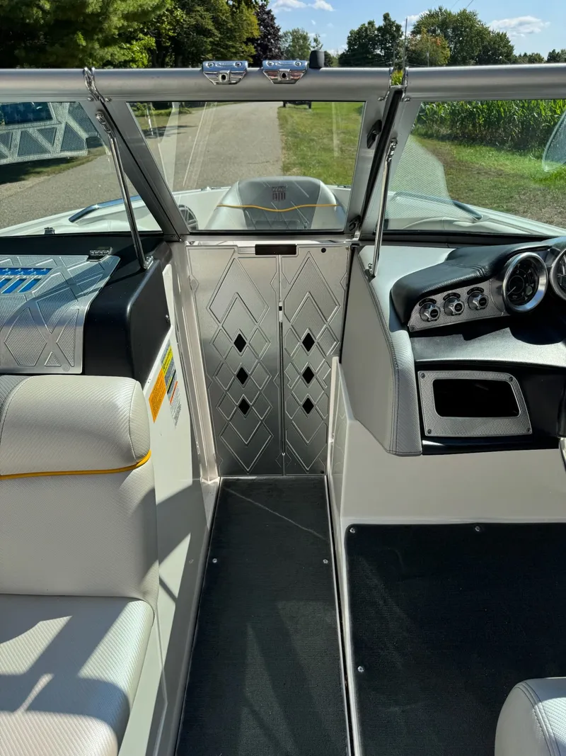 Slide: The Image of Interior view of a 2012 MasterCraft X-15 boat, showcasing seating and dashboard. - 12